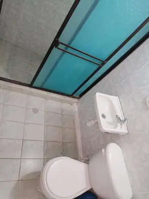 a bathroom with a toilet and a sink at Casa de relajación low cost in La Dorada
