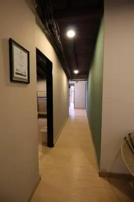 a hallway with a long hallway with a room with a hallwayngthngthngthngth at Apartamento Centro Comercial los Molinos - ONE203 By Roots Rentals in Medellín