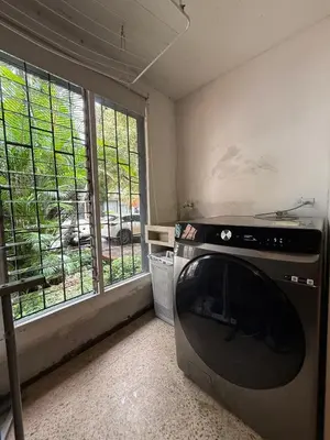 a kitchen with a stove and a large window at Apartamento cerca a clínica las Américas - ONE204 By Roots Rentals in Medellín