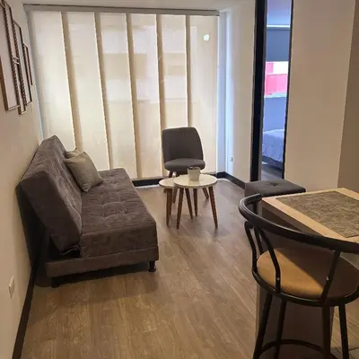 a living room with a couch and a chair and a table at Apartamento nuevo centro histórico! in Manizales