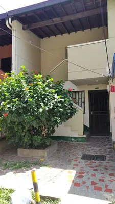 a building with two large bushes in front of a building at Cápsula Urbana Central #4 in Medellín