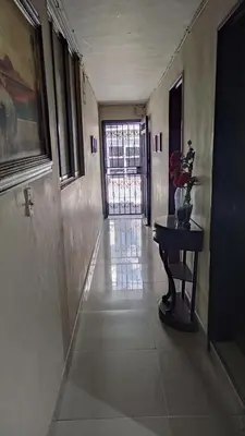 a hallway with a table and a door in a building at Habitación sencilla y central #6 in Medellín