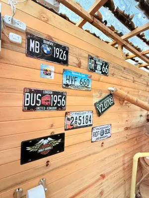 a wall with many signs on a wooden wall at Glamping Colibrí, bosque vecino y vista a la montaña al mismo tiempo in Jardin