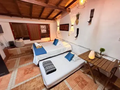 an overhead view of a room with two beds and a table at Casa & cabaña campestre equipadas, 13 personas, familias in Jardin