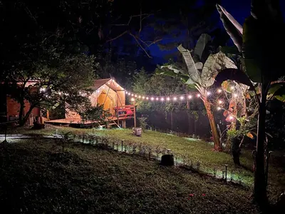 a garden at night with a tent with lights at Cabaña & glamping para grupos de 4 a 6 personas, cerca al parque y con avistamiento de aves in Jardin