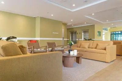 a living room with two couches and a table at El Tesoro Medellín Hab314 by Letoh in Medellín