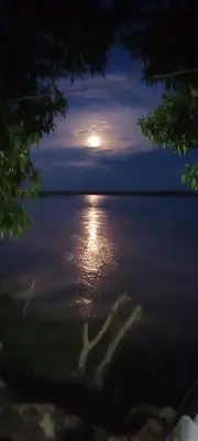 a view of a full moon over a body of water at Hospedaje Luz d' Luna in Puerto Triunfo
