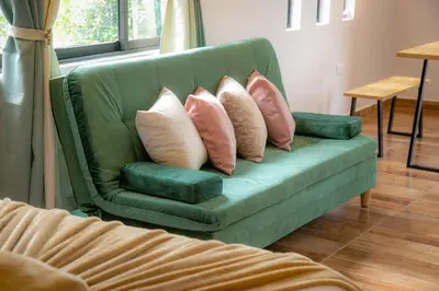 a green couch with four pillows on it at loft grupo y parejas AZUCENAS in Jardin