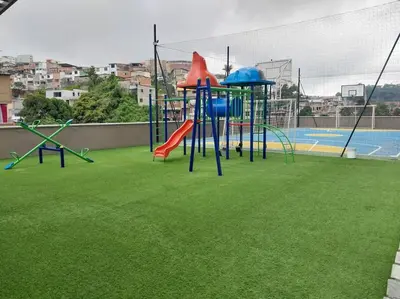 a playground with a slide on a field of grass at Apartamento Manizales II in Manizales