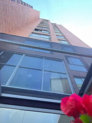 a tall building with a window on the side of it at Poblado 1 hasta 4 personas in Medellín