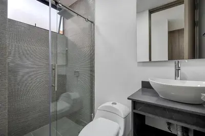 a bathroom with a glass shower and a sink at Medellin-Cerca al Poblado-201 in Medellín