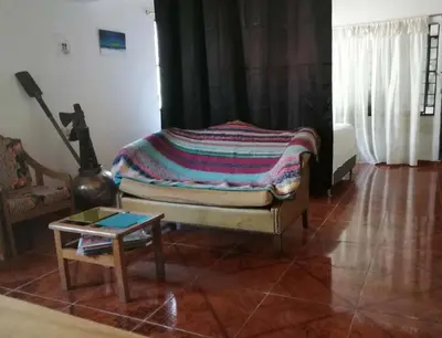 a living room with a bed and a table at Casa Rio y Montaña in Honda
