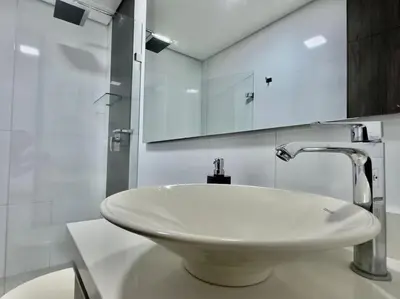a bathroom with a white sink and a mirror at 802, Amazing apartment in heart of El Poblado + View! in Medellín