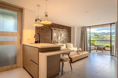 a kitchen and living room with a table and a couch at San Telmo Lake Guatape view in Guatapé