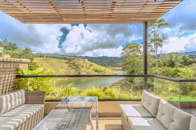 a living room with a view of a river at San Telmo Lake Guatape view in Guatapé