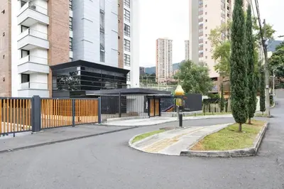 a street in a city with a fence and a building at 302 Spacious apartment nice view in El Poblado in Medellín