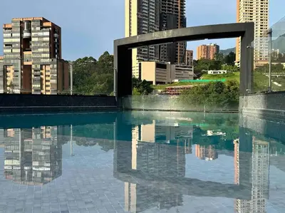 a pool of water with buildings in the background at 502 El Poblado: Beautiful & ample space for families in Medellín