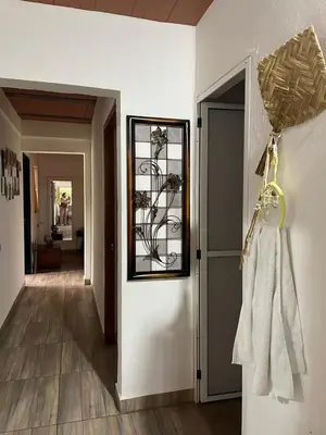 a hallway with a door with a clock on the wall at Las 5 Quintas - Acogedora casa in San Rafael