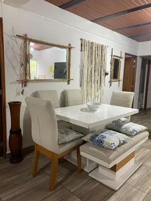 a dining room table and chairs with a white table and a mirror at Las 5 Quintas - Acogedora casa in San Rafael