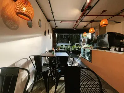 a dining room with a table and chairs in a restaurant at Económicas habitaciones amobladas en Medellín con oficinas, puesto de trabajo, cocina, baño y lavandería comunes Be Together by Roots Rentals TOG401y402 in Medellín