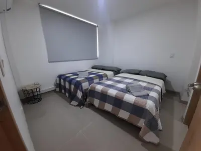 a bedroom with two beds in a white room at Disole 504 in Santa Fe de Antioquia