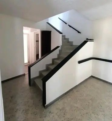an empty room with stairs in a house at Acogedor Loft con Balcones para 2H Belén Rosales apt 201 in Medellín