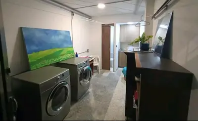 a laundry room with a washing machine and a tv at Acogedor Loft con Balcones para 2H Belén Rosales apt 201 in Medellín