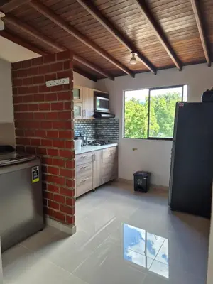 a kitchen with a brick wall and a brick pillar at EXCLUSIVO y ELEGANTE APARTAMENTO in Medellín