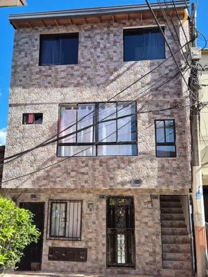 a brick building with glass windows on it at ECXEPCIONAL y ELEGANTE APARTAMENTO in Medellín