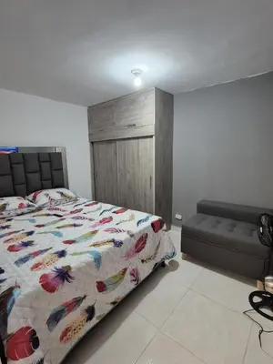 a bedroom with a bed with a colorful comforter at BONITO y ELEGANTE APARTAMENTO in Medellín