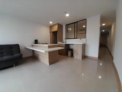 a kitchen with a counter and a couch in a room at Medellin laureles mejor ubicación in Medellín