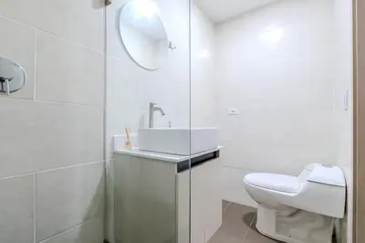 a white bathroom with a sink and a toilet at Apartamento en maravilloso Laureles con piscina 801 in Medellín