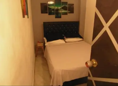 a small bedroom with two beds in a room at Hospedaje J&L in Medellín