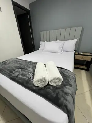 a bedroom with a bed with two towels on it at Hotel Casa Florida 70 Medellin in Medellín