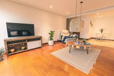 a living room with a television and a table at Habitación de Comfort total en el Poblado - A2 in Medellín