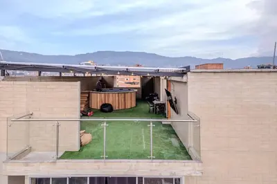 a backyard with a table on the roof of a building at Apartamento centrico en Laureles con piscina 301 in Medellín