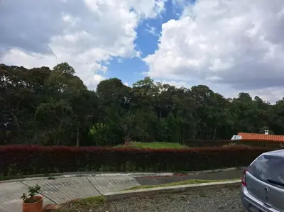 a car parked in a parking lot next to a hedge at Casa San Miguel Santa Elena in Medellín