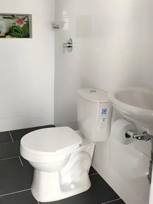 a white bathroom with a toilet and a sink at CASA ESTADIO MEDELLIN Apartamentos Turisticos renovados y modernos cerca al METRO - Barrio Laureles-Estadio in Medellín