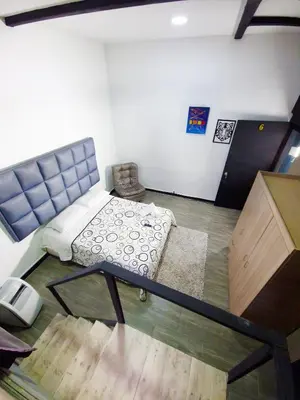 an overhead view of a room with a bed and a desk at Urban 8 Bedrooms Apartment at Poblado in Medellín