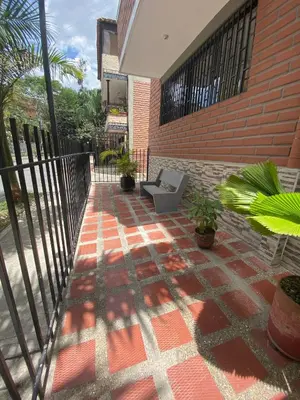 a patio with a chair on the side of a building at Céntrico Familiar Vive y disfruta Medellín 107 in Medellín