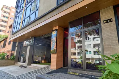 a store front of a building with glass windows at Charming Aparta-Suite Stadio Rosa Negra Retreat in Medellín
