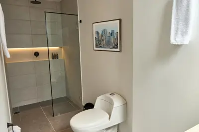 a bathroom with a toilet and a shower at Rosa Negra Haven Cozy Stadio Aparta-Suite in Medellín
