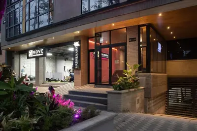 a store front of a building with plants and flowers at Comfortable Stadio Suite Rosa Negra in Medellín