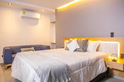 a bedroom with a large white bed in a room at Stadio Serenity Rosa Negra Aparta-Suite in Medellín
