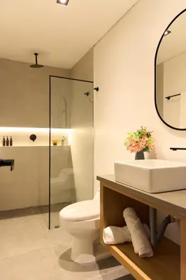 a bathroom with a sink and a toilet and a mirror at Elegant Cozy Suite Rosa Negra Stadio in Medellín