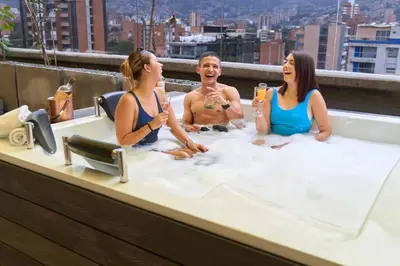 a group of three people sitting in a bathtub at Stadio Serenity Suite | Rosa Negra in Medellín