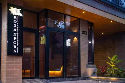 a building with a sign on the side of it at Comfortable Escape | Rosa Negra Stadio ApartaSuite in Medellín