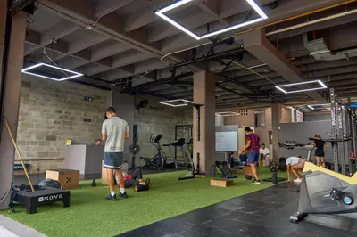 a group of people exercising in a gym at Cozy Getaway | Rosa Negra Stadio Suite in Medellín