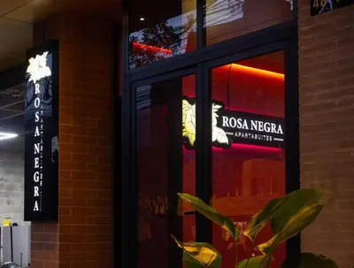 a window of a rico nedera restaurant at Warm and Cozy Stadio Suite Rosa Negra in Medellín