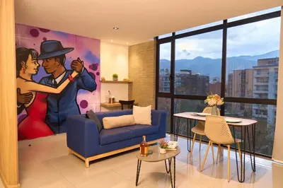 a living room with a painting of a couple kissing at Warm and Cozy Stadio Suite Rosa Negra in Medellín